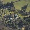 Oblique aerial view centred on the country house, gardens and cottages, taken from the SW.