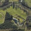 Oblique aerial view centred on the country house and walled garden, taken from the WNW.