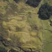 Oblique aerial view centred on the remains of the sheepfold and the quarry, taken from the W.