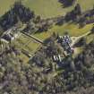Oblique aerial view centred on the country house, cottages and walled garden, taken from the W.