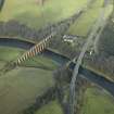 Oblique aerial view centred on the Leaderfoot railway viaduct, Drygrange Bridge and new road bridge, taken from the SE.
