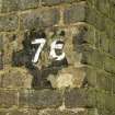 Detail.  From N of farm access footbridge bridge pier shoing original painted bridge number.