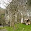 View.  From NW and at ground level showing three of the concrete arches.