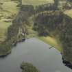 Oblique aerial view centred on the reservoir, dam and cottage, taken from the NW.