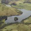 General oblique aerial view centred on the reservoir, dam and cottage, taken from the ENE.