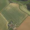 Oblique aerial view centred on the parchmarks of the settlement, taken from the WNW.