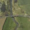 Oblique aerial view centred on the road bridge, taken from the NE.