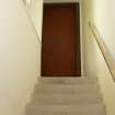 Interior. View of stairs and door to gallery