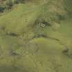 Oblique aerial view centred on the remains of the township and rig, taken from the NE.