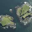 Oblique aerial view of the islands centred on the remains of the castles, taken from the N.