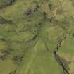Oblique aerial view centred on the remains of the township and field-system, taken from the SE.