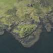 Oblique aerial view centred on the remains of the dun, taken from the ESE.