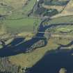 General oblique aerial view centred on the rail bridge and the road bridge with the remains of the castle in the foreground, taken from the SW.