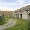 Courtyard. E Side cartshed arches. View from SSW