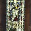 Interior. View of nave stained glass window by Charles E Kempe