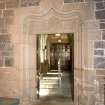 Interior. View of doorway in E side chapel leading to priest's house (door open)