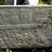 Fragment of west highland grace slab showing tip of sword, shears and decoration