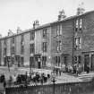 GLASGOW, KINNING PARK, ST. JAMES TERRACE
Digital copy of historic photograph showing general view of houses with large group of children outside.
Titled below: ' 3 dwellings, 3 apartments, 24 dwellings, 1 apartment: 2 wash-houses containing in all 29 taps and 8 W.Cs '.