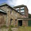 View looking NW  with rear of what was the original early 19th century mill building, now Administration block above the Drystore and Tanyard (right). The extreme left building is a later addition to the 2 storey building in the centre of the image.