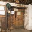 Interior. Main Building, 4th floor/Top Flat. View of taking in door with pulley for hoist. This originally ran off the water wheel until the waterwheel was removed in the 1950s.