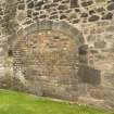 Detail of blocked arched entrance in warehouse wall