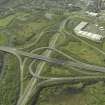 Oblique aerial view centred on the motorway interchange, taken from the NE.