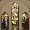 Interior. View of  three light stained glass window in chancel