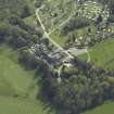 Oblique aerial view centred on the country house with the caravan park adjacent, taken from the N.