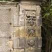 Detail of gate pier to NE of main house showing carved stonework from S.