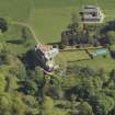 Oblique aerial view centred on the house with the stable block adjacent, taken from the SW.