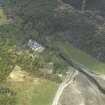 Oblique aerial view centred on the hunting lodge with the church and burial ground adjacent, taken from the S.