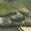 Oblique aerial view centred on the country house with the Collegiate Chapel adjacent, taken from the ESE.