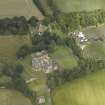 Oblique aerial view centred on the country house with the Collegiate Chapel adjacent, taken from the W.