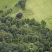 Oblique aerial view centred on the burial vault with the country house adjacent, taken from the NE.