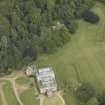 Oblique aerial view centred on the country house with the burial vault adjacent, taken from the W.
