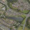 Oblique aerial view centred on the canal basin and the housing, taken from the NW.