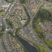 Oblique aerial view centred on the canal basin and the housing, taken from the W.