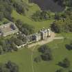 Oblique aerial view centred on the country house and stables, taken from the SW.