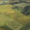 Oblique aerial view centred on the cropmarks of the settlement with coach house and stable adjacent, taken from the NNE.