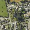 Oblique aerial view of Newtyle village centred on the Church, taken from the NE.