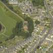 Oblique aerial view centred on the water tower with the high school adjacent, taken from the S.