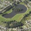 Oblique aerial view centred on the reservoir with the water tower and high school adjacent, taken from the ESE.