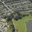 Oblique aerial view centred on the water tower with the high school adjacent, taken from the NW.