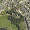 Oblique aerial view centred on the water tower with the high school adjacent, taken from the SW.