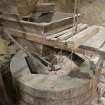 Interior. First floor. Detail of 'Damsel ' or grain feed apparatus and the hopper as it feeds grain into the grinding stones.