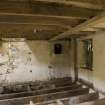 Interior. First floor. Storage area from milling floor . Note sack hoist frame in floor joists and shute openings into the kiln floor.