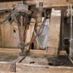 Interior. Ground floor. Sieve, note the shutes from the shelling (left) and the grinding stones (right). Note belt drive from gear cupboard which shakes the sieve which is suspended by leather straps.