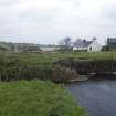 View looking NE towards mill, Millquoy (former miller's cottage) to right and inner face of dam wall and sluice.