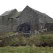 View of NW elevation of mill building with waterwheel frame.