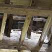 Interior. View of floor beams and wall head and roof.